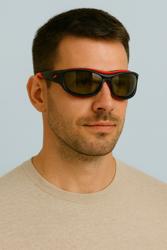 Ein Mann trägt eine schwarz-rote Sportbrille.