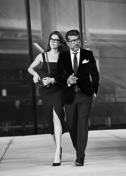 Eleganter Mann mit Zigarre, und junger Dame mit elegantem Kleid und schwarzen Acetat Brillen von Robert la Roche. Schwarzweiß