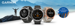 drei Garmin Smartwatch-Modelle von Hartlauer mit einem Wanderer und Bergen im Hintergrund 