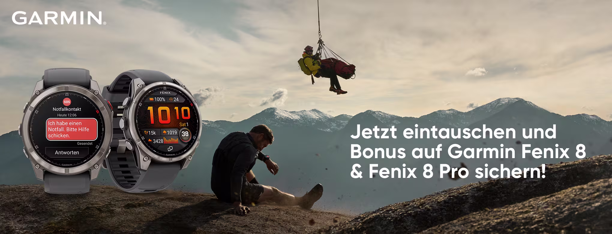 Breites Werbebanner mit Garmin‑Logo oben links, zwei Fenix 8‑Uhren links, verletzter Wanderer auf einem Gipfel, Rettungsaktion per Seil dar&uuml;ber, weiter Berghorizont; rechts der gro&szlig;e Werbetext: &bdquo;Jetzt eintauschen und Bonus auf Garmin Fenix 8 & Fenix 8 Pro sichern!&ldquo;.