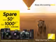 Ein Löwe sitzt in einem Feld und im Hintergrund fliegt ein Heißluftballon. Daneben sind zwei Objektive, drei Kameras und ein Fernglas von Nikon zu sehen sowie folgender Text: "Spare von 50€ bis 1000€. 02.05. bis 21.07.2025."