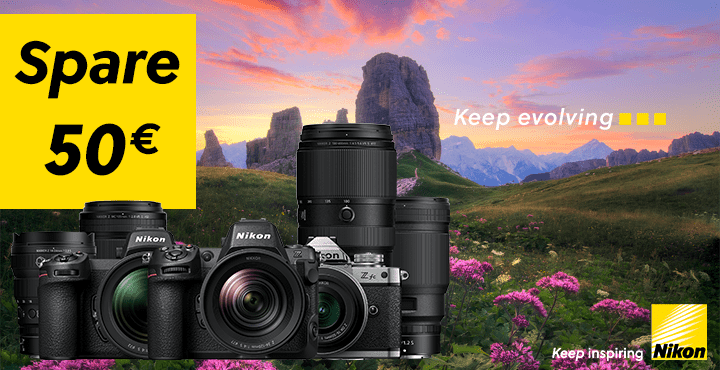 Banner einer Nikon Sommer Sofortrabatt Aktion mit folgendem Text: "Spare 50€." Im Hintergrund sieht man eine hügelige, grasbewachsene Landschaft mit Blumen und Bergen. Zusätzlich sind mehrere Nikon Kameras und Objektive abgebildet.