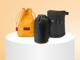 Verschiedene Kamera-Objektivtaschen auf einem Tisch. Eine gelbe Leder-Beuteltasche, eine schwarze kleine Stoff-Beuteltasche und ein festeres Stoff-Case mit Reißverschluss. 