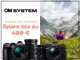 Eine Person sitzt auf einer Blumenwiese in den Bergen und blickt in die Ferne. Zwei Kameras und zwei Objektive von OM System sind zu sehen sowie folgender Text: "OM System. Verewige dein Abenteuer. Spare bis zu 400€."