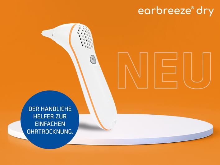 das Gerät earbreeze dry von Hartlauer auf orangem Hintergrund und earbreeze-Logo
