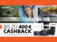 Zwei Kameras und drei Objektive von Sony befinden sich neben folgendem Text: "Sony. The choice of creators. Bis zu 400€ Cashback. Aktionszeitraum: 01. April bis 31. Juli 2025." Im Hintergrund befinden sich drei Fotos. Auf dem ersten Foto ist ein Vogel über dem Wasser zu sehen, auf dem zweiten eine Frau und auf dem dritten ein See.