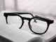 Eine schwarze Bifokalbrille liegt auf einem geöffnetem Buch.