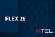 Tarif Flex 26 und MTEL-Logo vor unscharfem dunkelblauem Hintergrund mit Handyabteilung in Hartlauer Geschäft