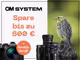 Grafik von OM System zur Bewerbung der Cashback Aktion mit folgendem Text: "OM System. Spare bis zu 600€." Auf der Grafik ist eine Kamera abgebildet, zu der es einen gratis Griff dazu gibt. Außerdem sind drei Objektive zu sehen. Rechts daneben ist ein Vogel abgebildet.